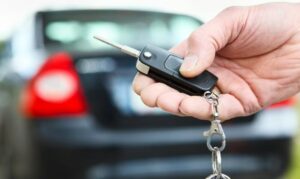Auto locksmith in Brisbane helping unlock a vehicle and retrieve car keys